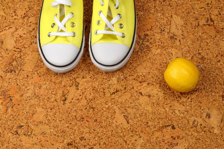 yellow sneakers on a background of cork Kork